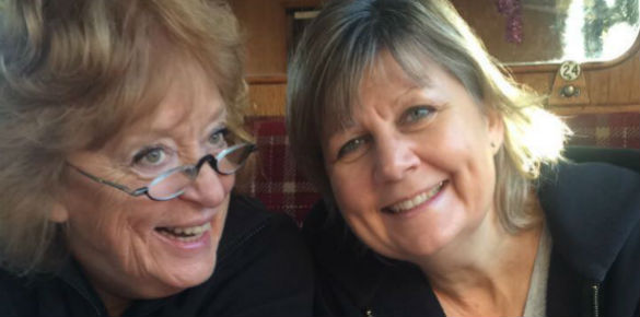 A head shot of two middle aged ladies, one with glasses. 